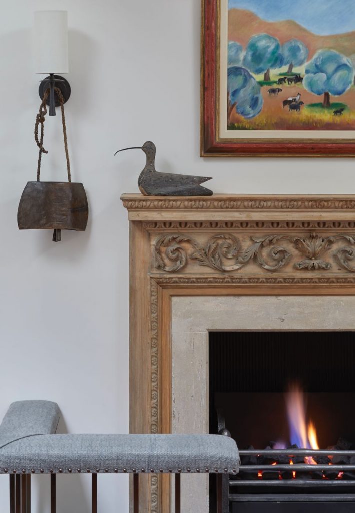 Antique pine carved fire surround with club fender and cow bell