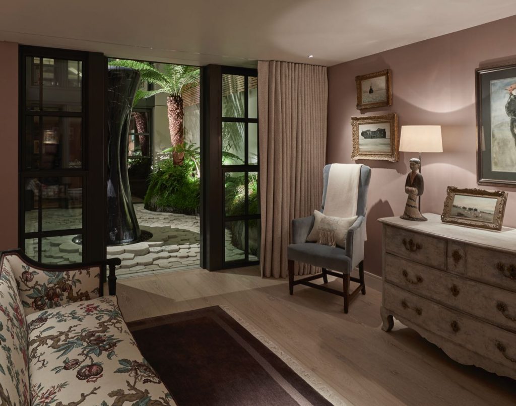 Master bedroom with concealed curtain track and high backed occasional chair