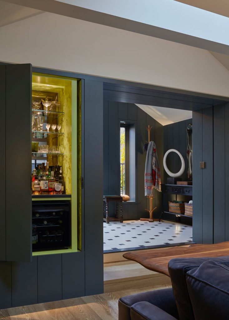 Concealed bar with pocket doors and Christian Lacroix wallpaper