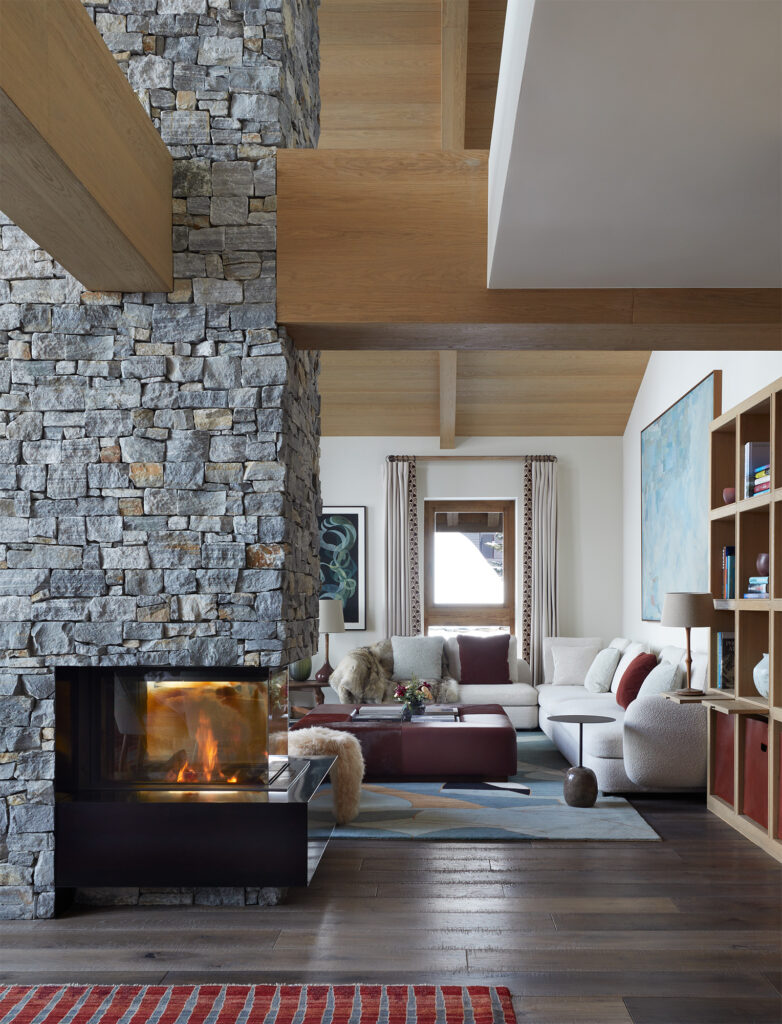 abstract hand knotted carpet by Marie Berthouloux central fireplace stone internal chimney chalet drawing room