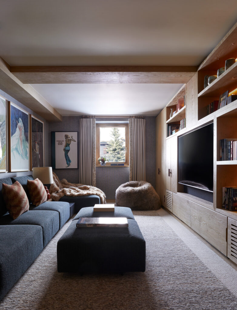 luxury Val d'Isere family chalet TV room, Hyde & Hare fur beanbag, Peter Doig artwork, blue modula sofa