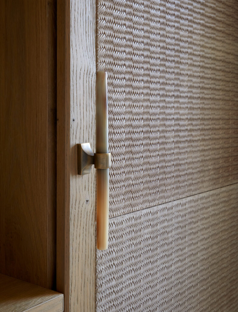 Suede embossed wardrobe doors and long horn and antique brass door handle