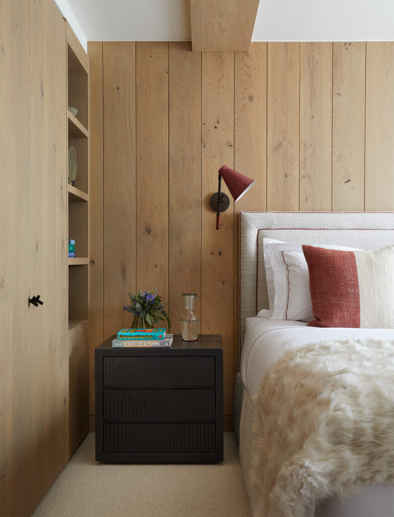 chalet with solid oak panelled walls terracota wallmounted anglepoise bedside lamp