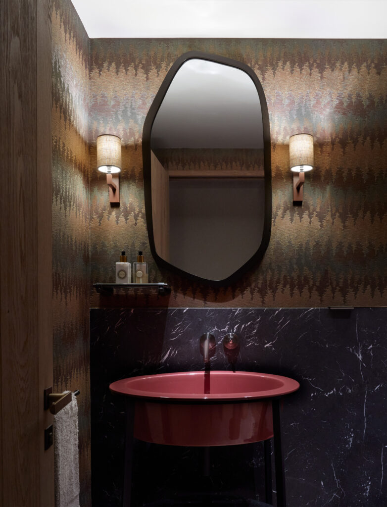 luxury chalet powder room, Missoni wallpaper, Porta Romana wall lights and red handbasin