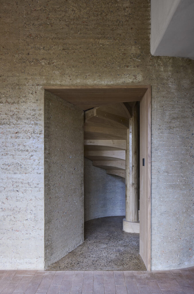 Rammed earth circular tower with spiral staircase